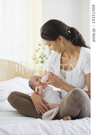 Mother feeding her baby a bottle 10351409