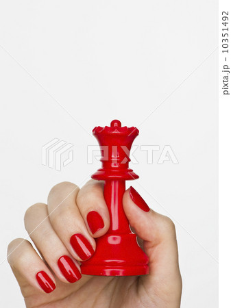 Hand holding red queen chess piece Hand holding red queen chess piece 10351492