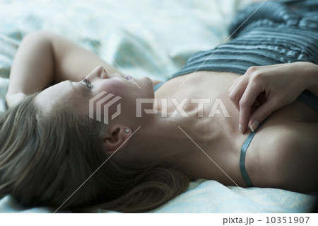 Woman lying down on bed 10351907