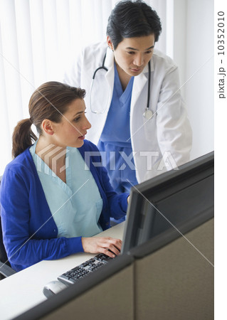 Doctor and nurse looking at computer 10352010