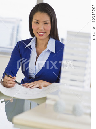Female architect looking at blueprints 10352202