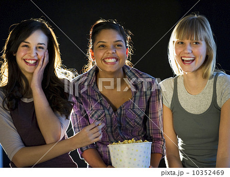 Young girls eating popcorn Young girls eating popcorn 10352469
