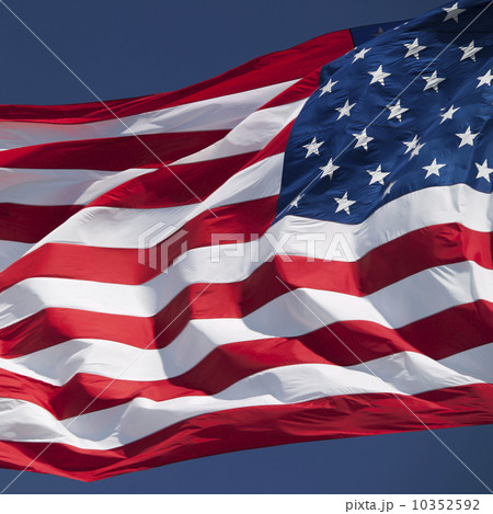 USA, South Dakota, American flag flapping against sky 10352592