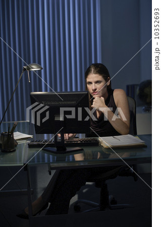 Woman working late in office Woman working late in office 10352693