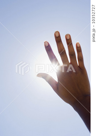 Hand held up in front of sunshine Hand held up in front of sunshine 10352727