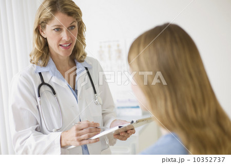 Doctor talking to patient in exam room Doctor talking to patient in exam room 10352737