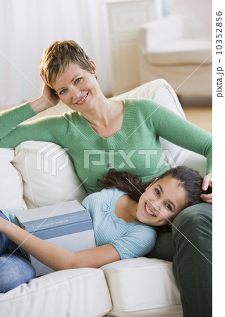 Mother and daughter relaxing on couch Mother and daughter relaxing on couch 10352856