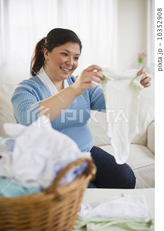 Overweight woman folding clothes 10352908