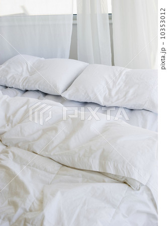 Bed with white linens Bed with white linens 10353012