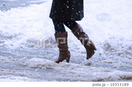 USA, New York, New York City, close up of woman's legs walking in winter slush USA, New York, New York City, close up of woman's legs walking in winter slush 10353189