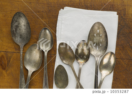 Close up of rusty silver spoons and napkin Close up of rusty silver spoons and napkin 10353287