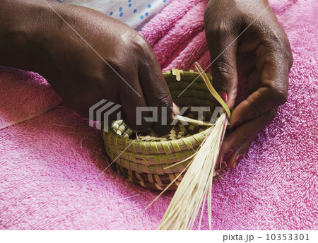 USA, South Carolina, Charleston, Hands of worker weaving sweetgrass 10353301