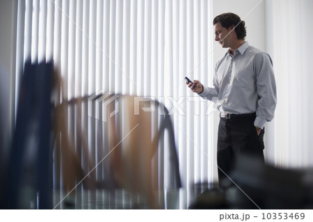Man in office using mobile phone 10353469