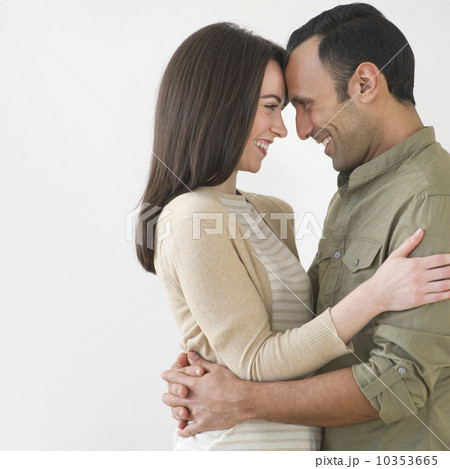 Happy couple embracing, studio shot 10353665