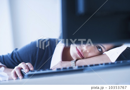 Businesswoman looking tired in front of computer 10353767