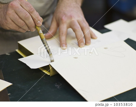 Craftsman making book bindings 10353810