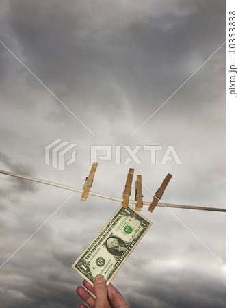 One dollar banknote drying on clothline 10353838