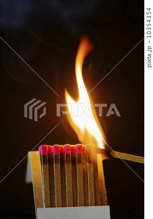 Close up of matches with one burning Close up of matches with one burning 10354354