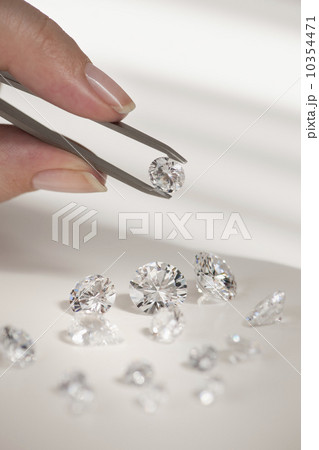 Studio shot of woman holding diamonds 10354471