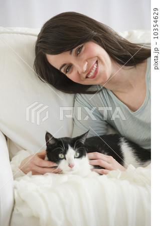 Portrait of woman with cat on sofa Portrait of woman with cat on sofa 10354629