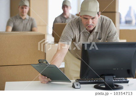 USA, New Jersey, Jersey City, man checking checklist in warehouse USA, New Jersey, Jersey City, man checking checklist in warehouse 10354713