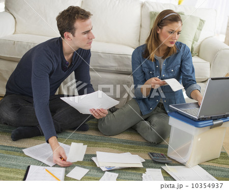 USA, New Jersey, Jersey City, Portrait of young couple doing paperwork at home USA, New Jersey, Jersey City, Portrait of young couple doing paperwork at home 10354937