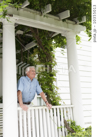 Senior man standing on porch 10355013