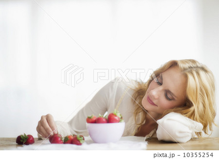 Woman eating strawberries, studio shot 10355254