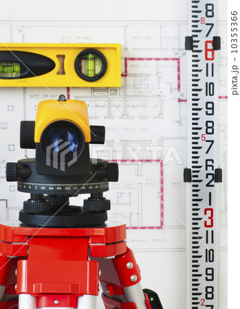 Close-up of theodolite, blueprint in the background 10355366
