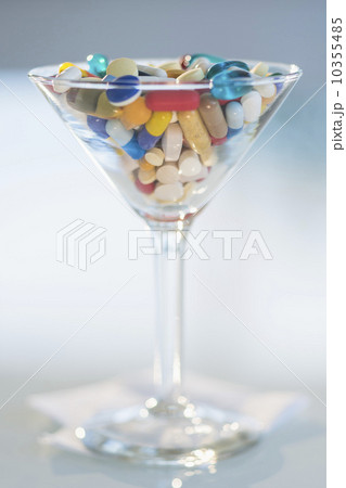 Studio shot of colorful pills in martini glass 10355485