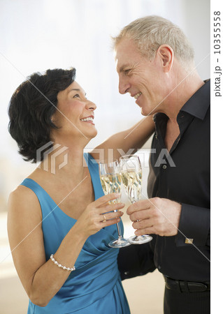Happy mature couple with flutes Happy mature couple with flutes 10355558