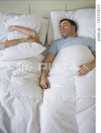 Couple in bed, man snoring 10355622