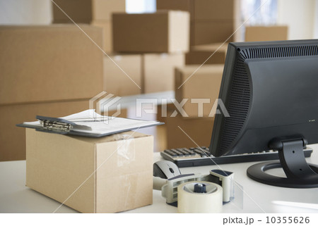 USA, New Jersey, Jersey City, boxes and computer at delivery warehouse 10355626