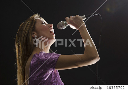 Woman singing in spotlight Woman singing in spotlight 10355702