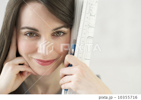 Close-up of woman holding ruler and pencil 10355716