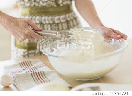 Midsection of woman whisking batter 10355721
