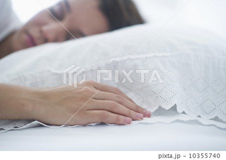 Happy young woman sleeping in bed 10355740