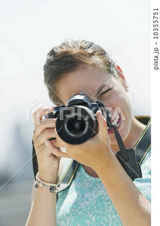 Portrait of young woman taking pictures with camera 10355751
