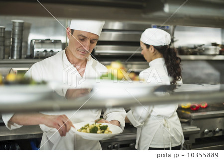 Chefs preparing food in kitchen 10355889