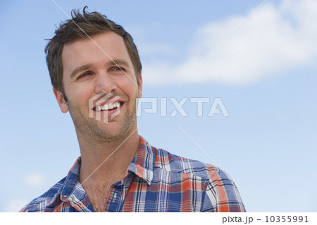 Portrait of mid adult man against blue sky 10355991