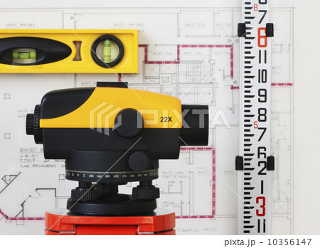 Close-up of theodolite, blueprint in the background 10356147