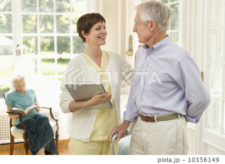 Senior man and nurse talking in nursing home 10356149