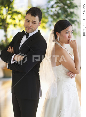 Bride and groom looking nervous standing back to back Bride and groom looking nervous standing back to back 10356345