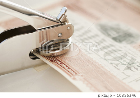 Close up of stamper making seal on stock share 10356346