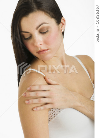 Studio shot of young woman caring for skin 10356367