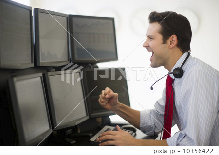 Financial worker analyzing data displayed on computer screen 10356422