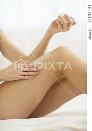 Studio shot of young woman caring for skin Studio shot of young woman caring for skin 10356441