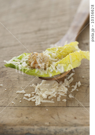 Fresh caesar salad on wooden spoon Fresh caesar salad on wooden spoon 10356628