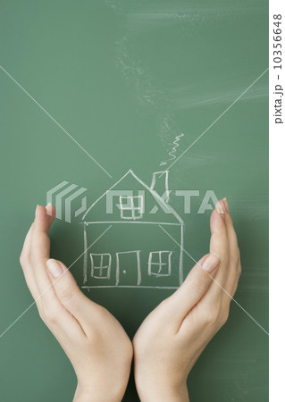 Woman holding hands around house drawn on blackboard Woman holding hands around house drawn on blackboard 10356648