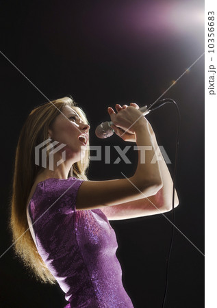 Woman singing in spotlight 10356683